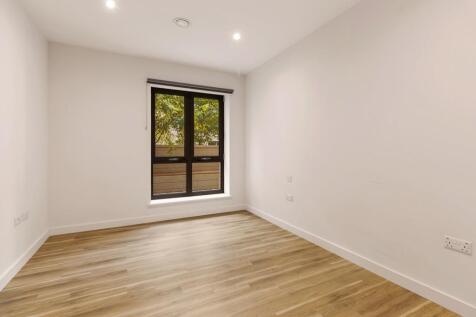 Step into this inviting space, perfect for a bedroom or office with its elegant wooden flooring and ample sunlight.