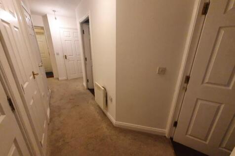Bright and tidy hallway with fresh white walls...