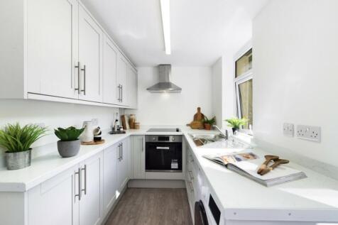A bright and modern kitchen with sleek cabinetr...