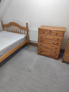 Cozy double bedroom with ample pine storage...