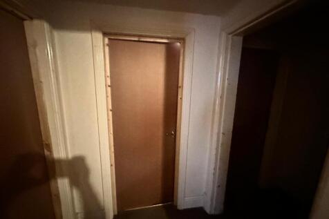 A well-defined hallway featuring clean walls an...