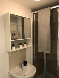 Well-kept bathroom with a compact basin, mirror...