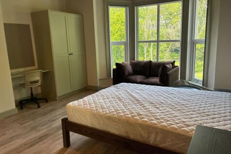 Spacious bright bedroom with bay window views...