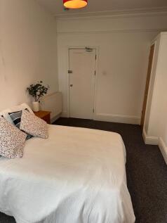 A cozy and inviting double bedroom featuring a ...