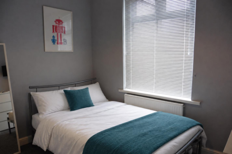 White bedding with teal accents.png