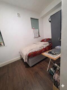 Cosy bedroom with sleek wood-style flooring...