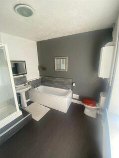 Stylish bathroom with full bath and shower cubi...