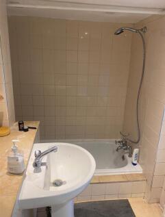 A functional bathroom featuring a combination b...