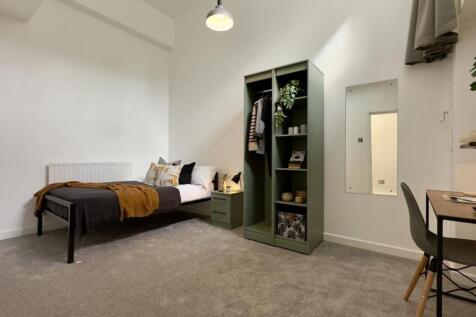 A stylish and well-lit double bedroom with mode...