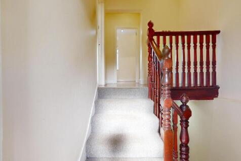 Bright upper-floor landing with neutral walls, ...