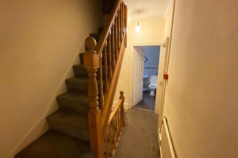 A clean and well-maintained hallway featuring a...