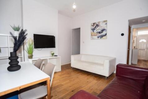 Stylish and inviting living room featuring ampl...