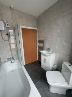 Modern tiled bathroom with a bath and shower, c...