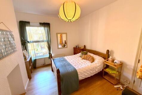 Bright bedroom with stylish wooden flooring...