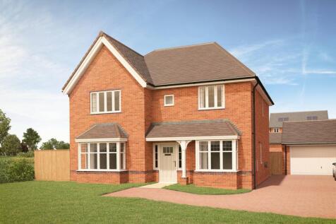 A modern brick house with a white front door and bay windows sits on a manicured lawn