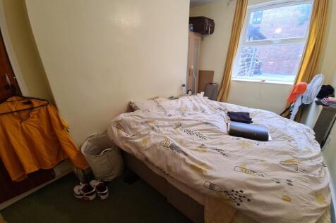 Cozy bedroom with a double bed positioned by a ...
