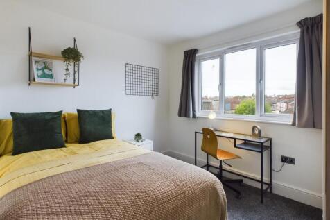 A bright and inviting double bedroom featuring ...