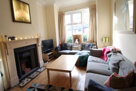 A bright and welcoming living room featuring co...
