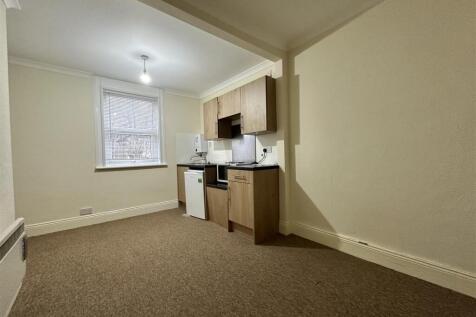 Bright kitchen area with contemporary cabinets...