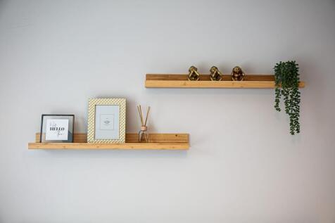 Minimal decorative wall shelves with framed pri...