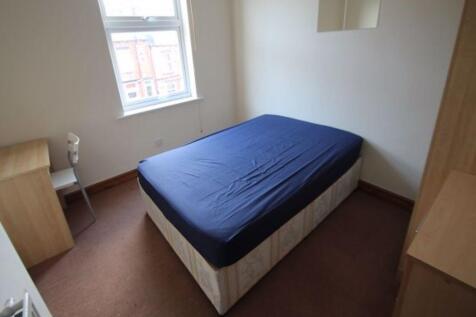 A simple and tidy double bedroom featuring a do...