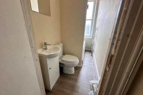 Compact bathroom with a modern sink and vanity,...