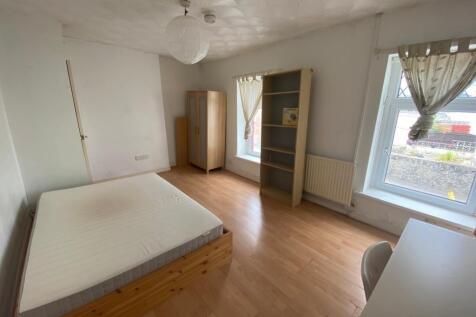 Spacious bright bedroom with ample storage spac...