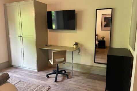 Modern study area with a wall-mounted TV....