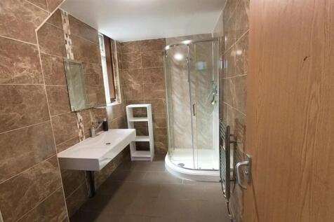 Elegant tiled bathroom with modern shower cubic...