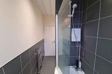 A modern bathroom featuring a tiled walk-in sho...