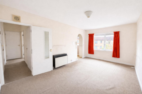 Bright living room with red curtains.png