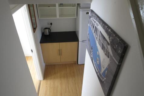 Bright, well-kept landing and hallway with wood...