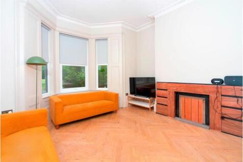 Spacious living room with bright bay windows...