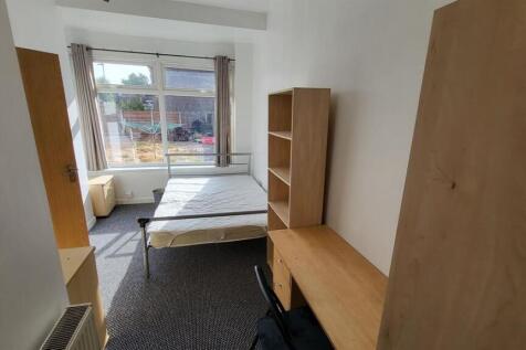 Bright, simply furnished bedroom with a large f...