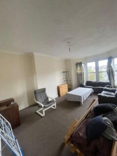 Spacious living room featuring large bay window...
