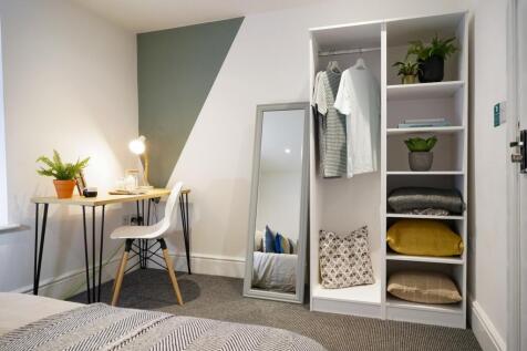 A bright and stylish double bedroom with a mode...
