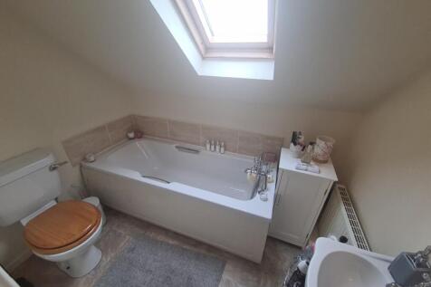 A spacious and well-maintained bathroom with a ...