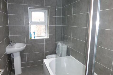 Modern tiled bathroom with a bath, shower enclo...