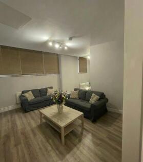 Well-presented communal lounge with two comfort...