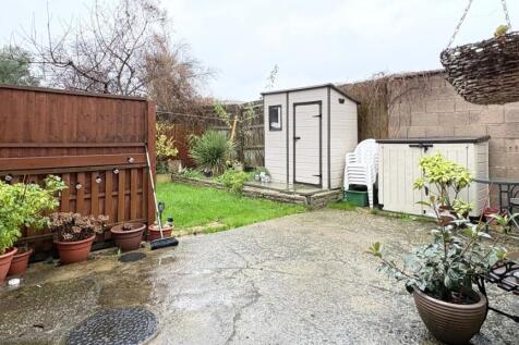 Private rear garden with paved patio, planted p...