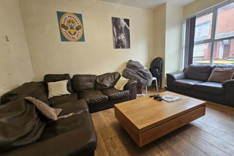 A spacious and inviting living room featuring a...