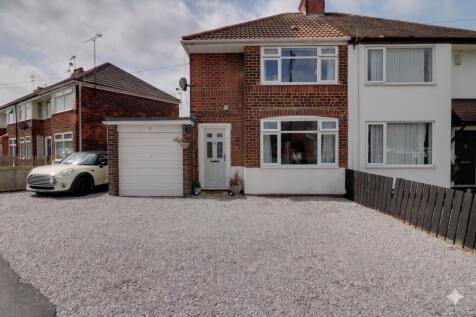 Front of house with drive and garage