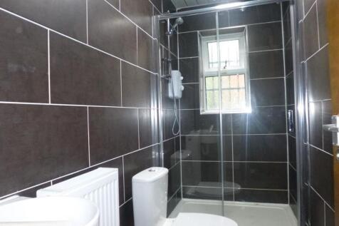 Modern tiled bathroom with a walk-in shower, wh...