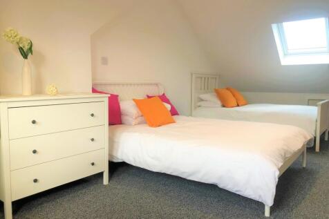 A bright and welcoming double bedroom featuring...