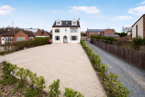 Suburban house with gravel driveway.png