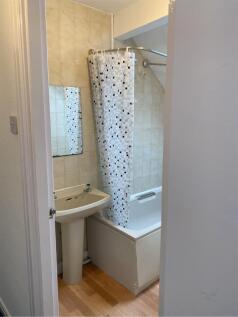 A tidy bathroom featuring a bathtub and modern ...