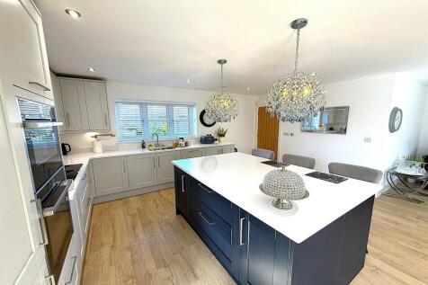 Elegant kitchen with large breakfast island and...