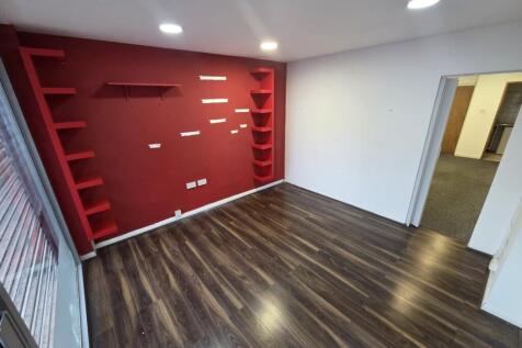 Modern lounge with feature wall and wood floors...