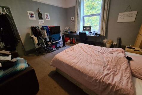 A cozy master bedroom featuring a comfortable d...