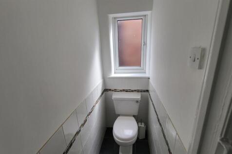 Compact, freshly painted restroom with a modern...